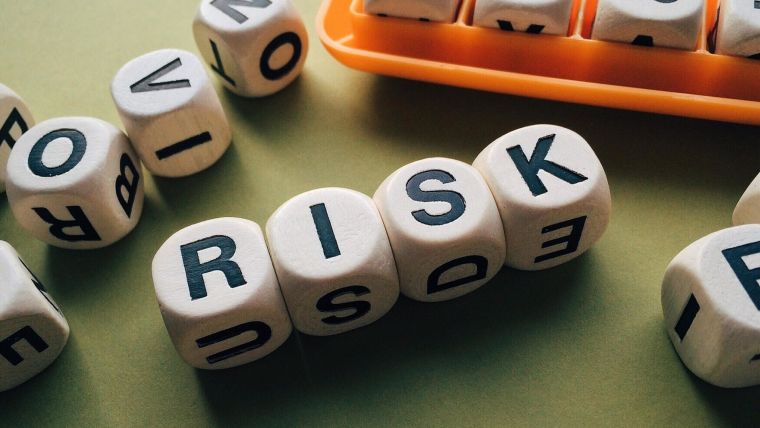 Wooden blocks spelling out 'RISK'